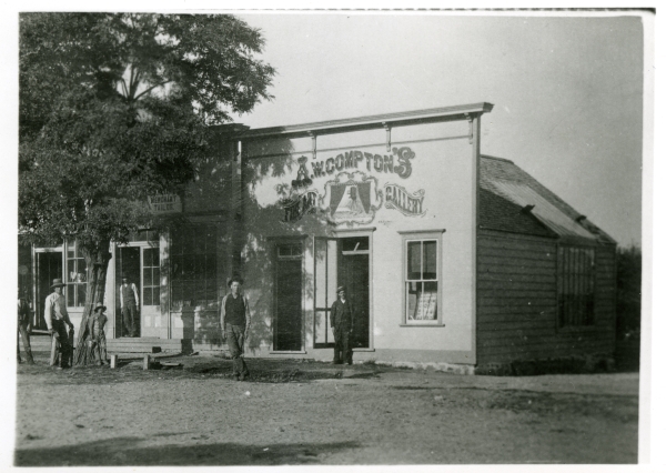 Black and white photo showing Compton's early photography studio - a small building with a facade that sticks up.
