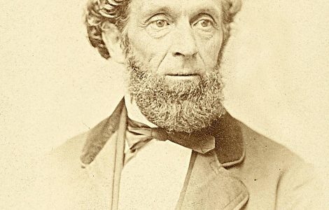 Sepia photo of Lorenzo Snow - man with curly hair and beard in a suit.