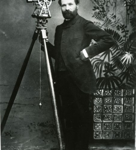 Photo of Nephi Anderson with surveying equipment